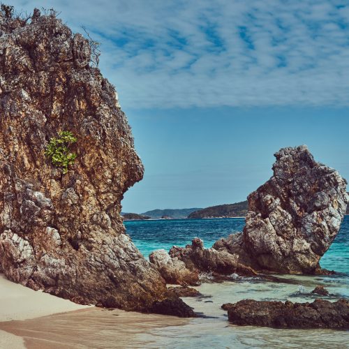 Beautiful landscape rocky stalactite reefs on the shore of Philippine Islands, Pacific ocean.